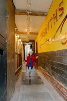 Little girl skipping along Tinsmiths Alley