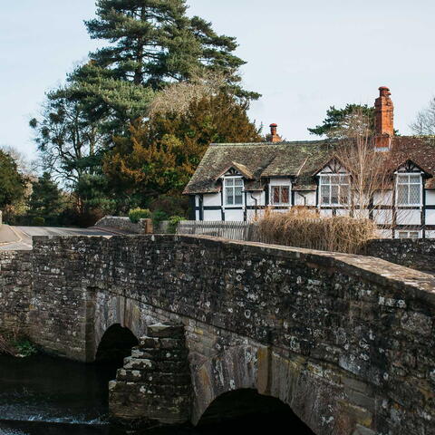 Eardisland Bridge with black and white house in the background