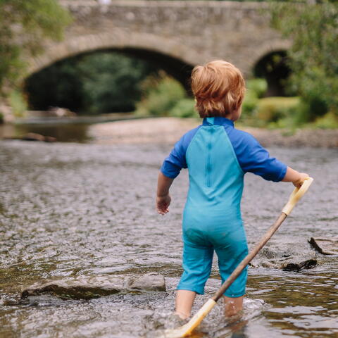 Child paddling in the river