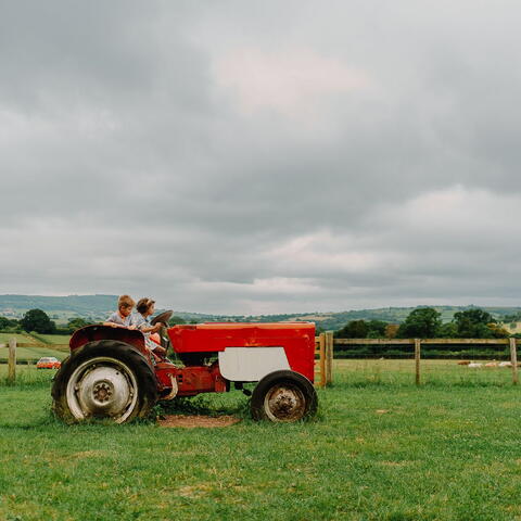 Kids playing on tractor at Rowlestone Court Farm