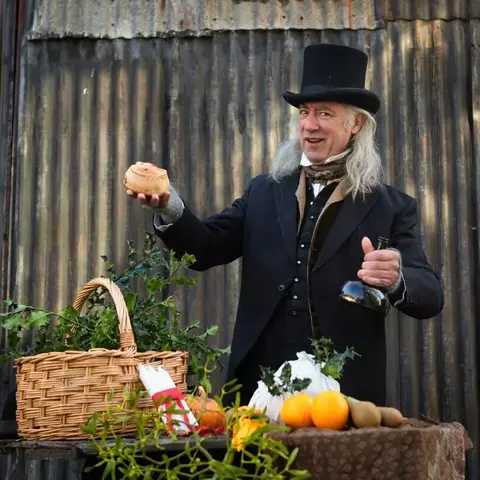 Victorian style dressed man with hamper