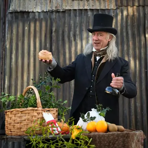 Victorian style dressed man with hamper