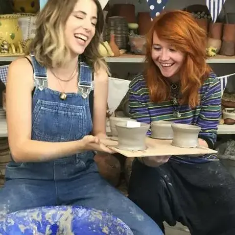 Course participants showing their pottery makes