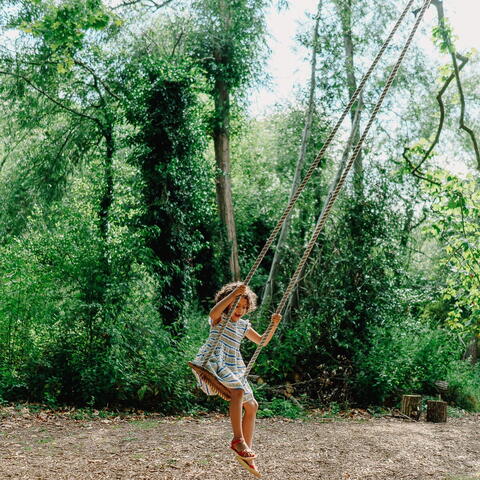 girl on rope swing at Hampton Court castle
