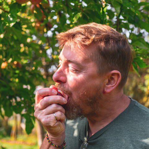 man biting into apple