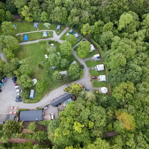 aerial view of campsite set amongst trees 