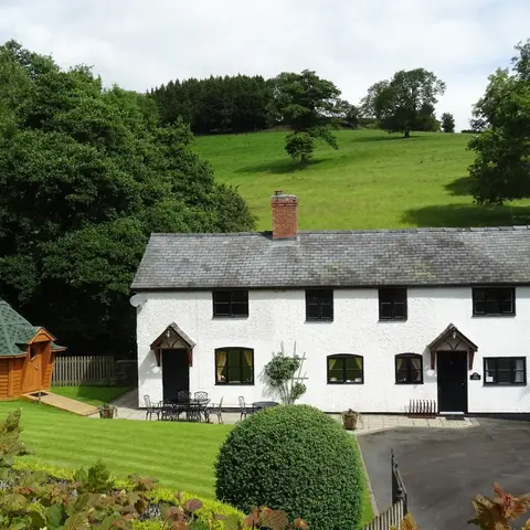 white house cottage set in rural countryside