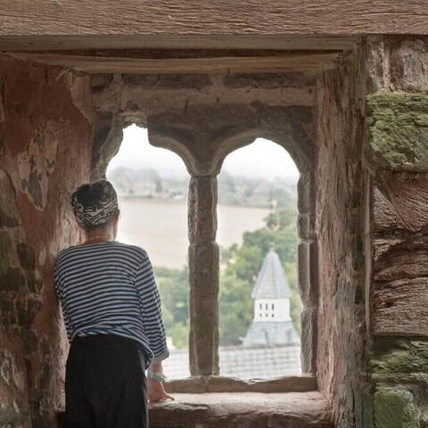 Woman looks out over hay castle during herefordshire histories festival