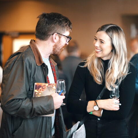 Couple chatting at wine tasting event