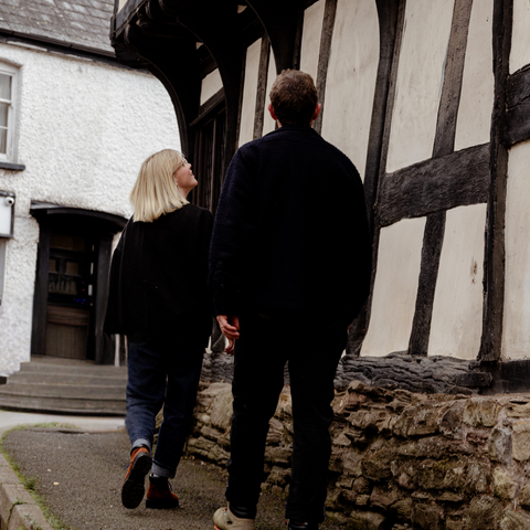 Man and woman walking in black & white village