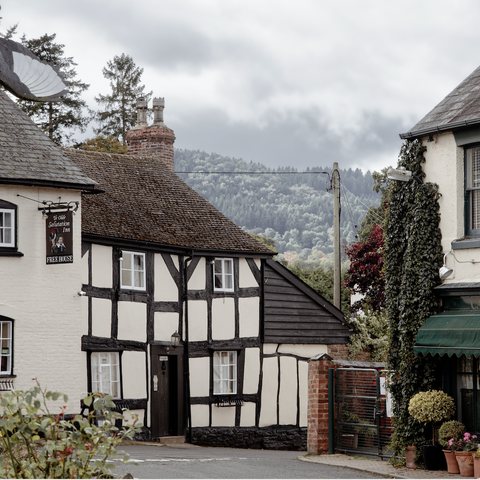 View of Weobley black and white houses with hills in the background