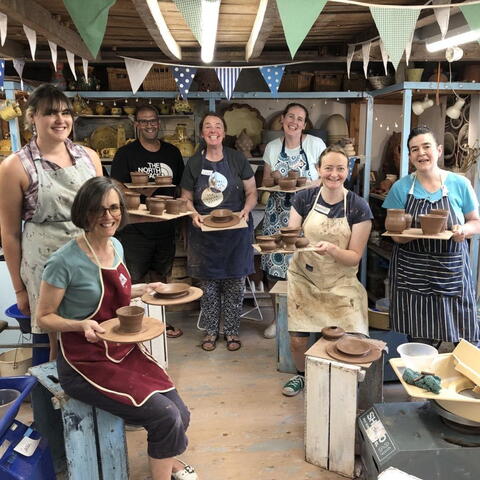 A group of people attending a pottery class at Eastnor Pottery