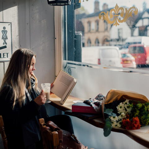 Woman reading book in cafe