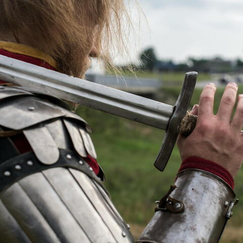 Sword on shoulder of knight