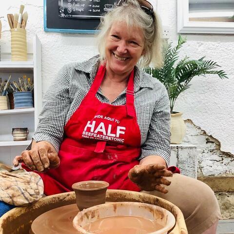 Lady Smiling whilst on the pottery wheel
