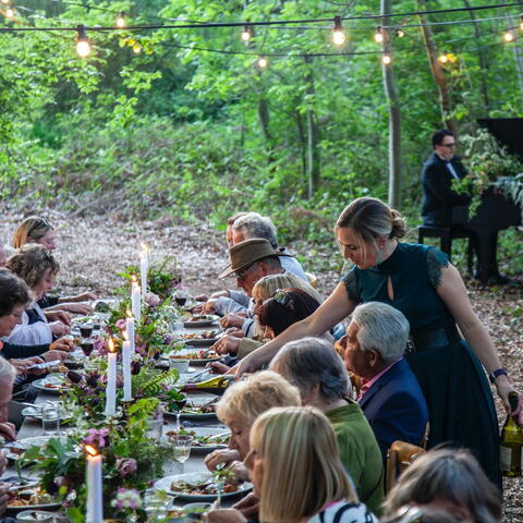 People sat at a table in the woods