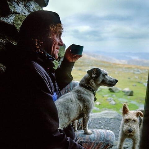 A man with his dog on top of the hill