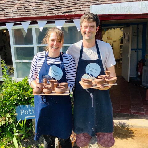 Couple showing their pottery