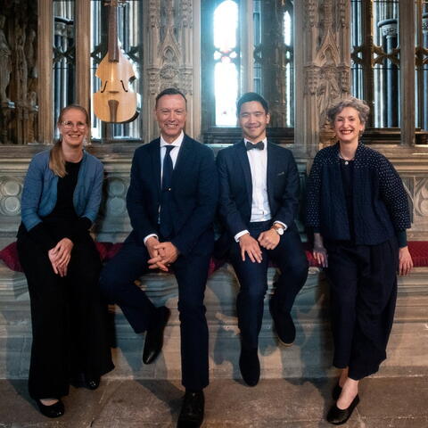 4 musicians standing