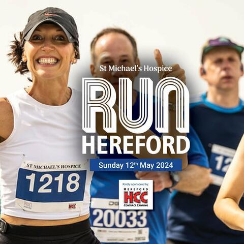 RUN Hereford banner. Lady in a cap and white vest with runner number on smiling 
