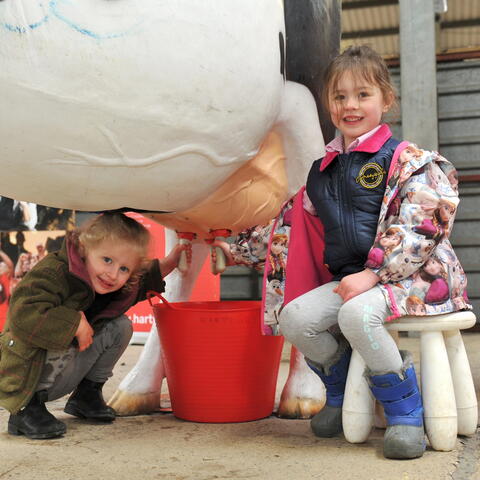 2 children practicing milking