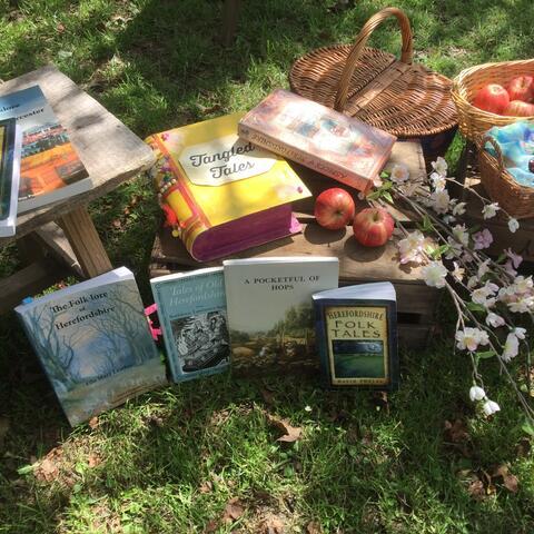 Books, fruit and flowers outside on wooden crates