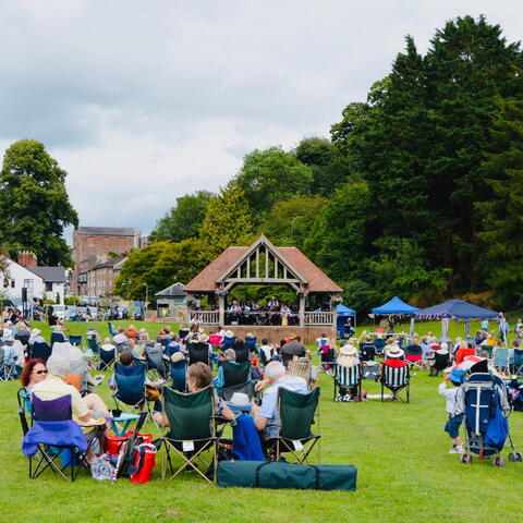 Bandstand with people sat in the park