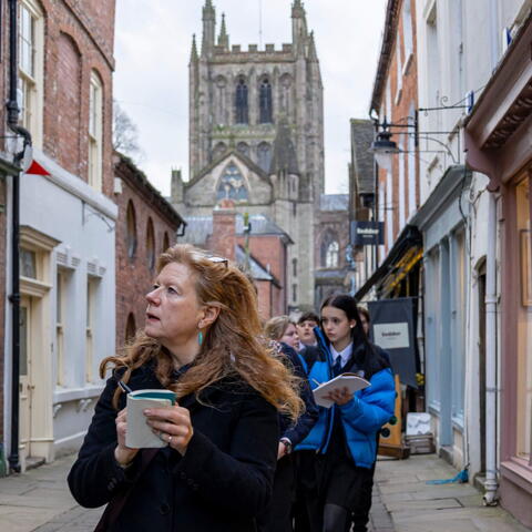 woman leading a city centre walk with teenagers