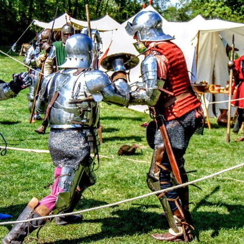 people dressed as knights in battle
