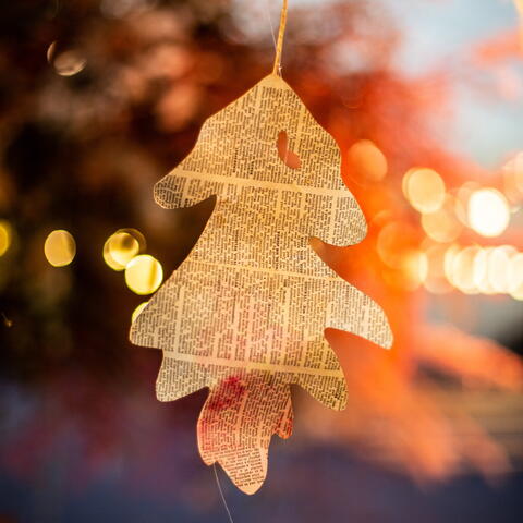 Paper tree hanging from a tree with warm lighting