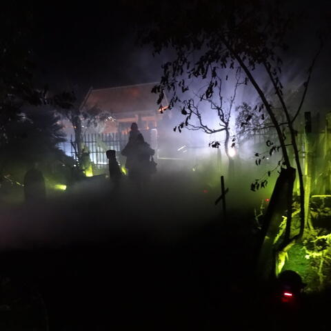 Spooky graveyard with white and green lighting
