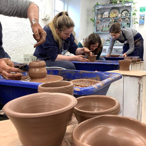 Close up of clay pots on potters wheel