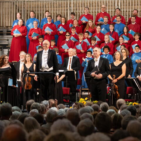 A large choir in red robes