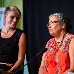 Two people on stage talking