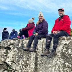 walkers sitting on stone wall 
